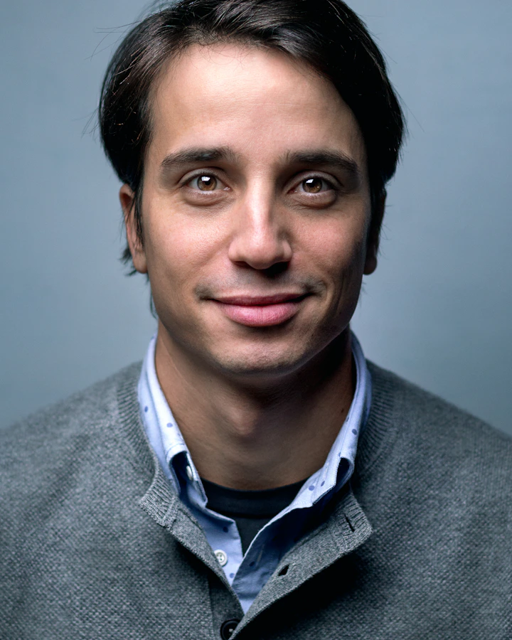 Man smiling in a cozy coffee shop