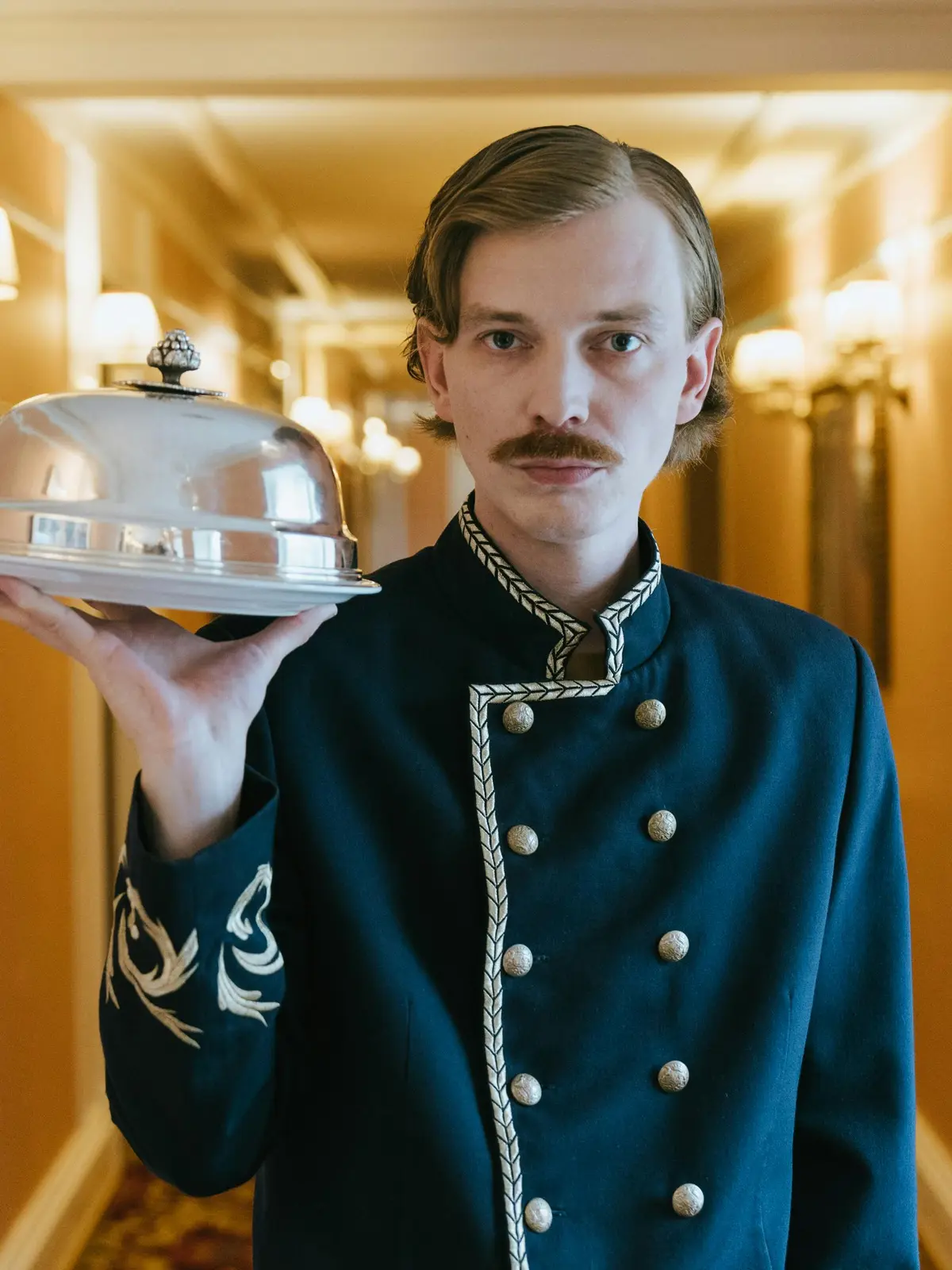 Hotel staff refreshing a guest suite with crisp linens