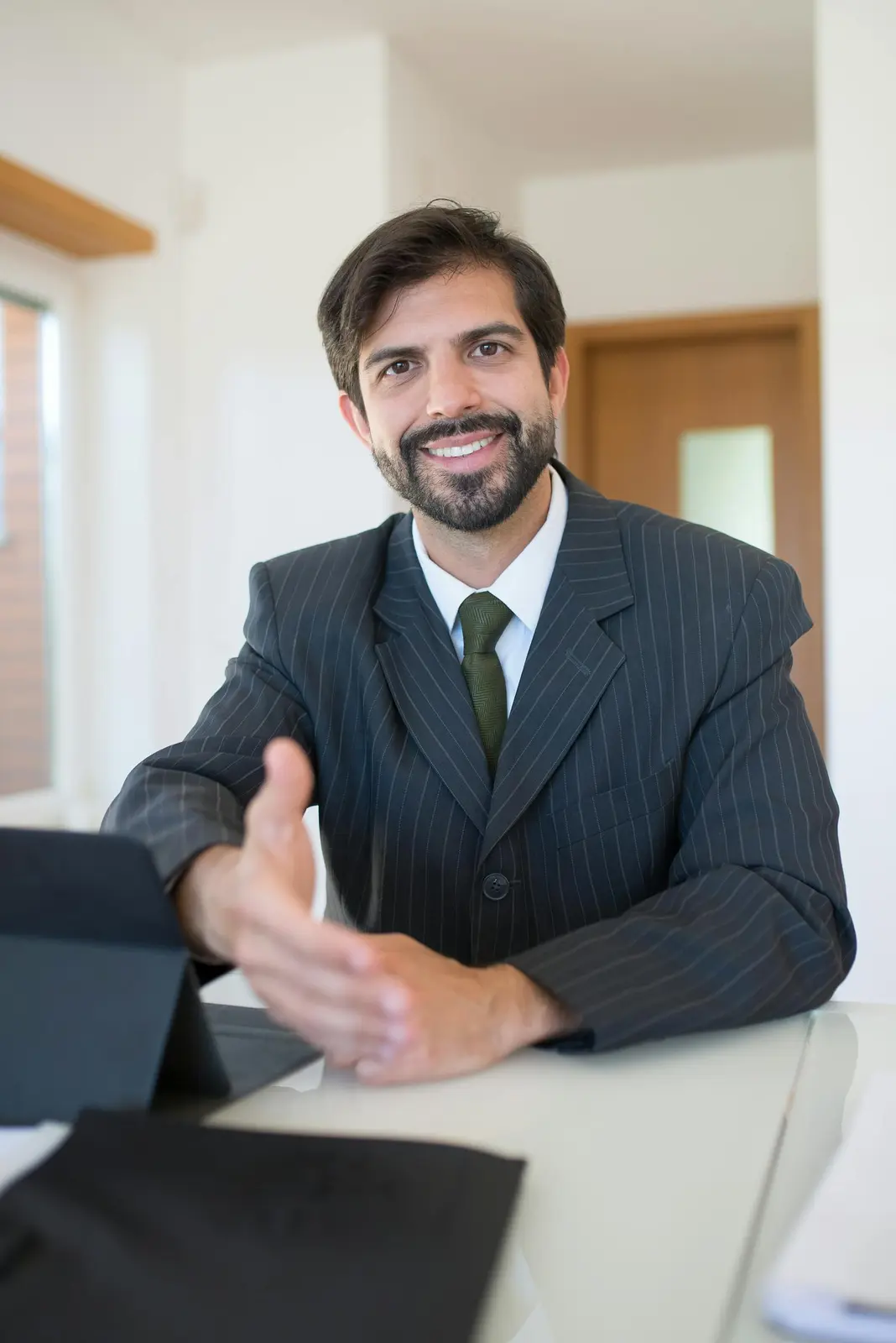 Two real estate professionals collaborating over marketing plans at a bright office table
